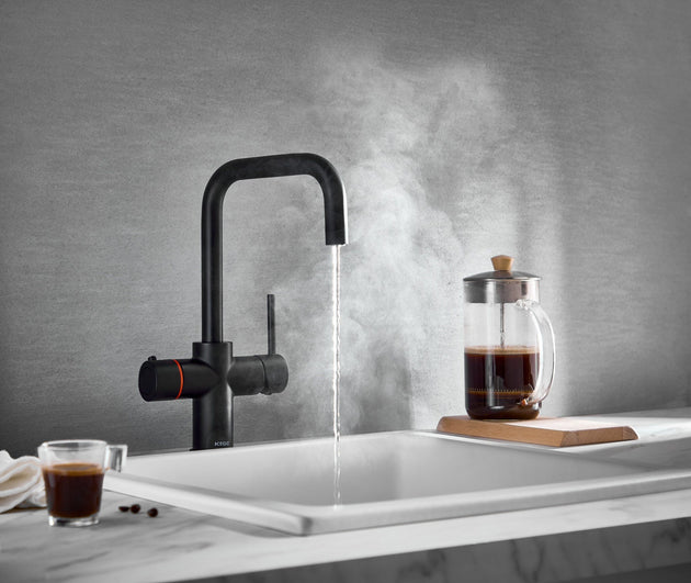 Are Boiling Water Taps Worth It? 2026 UK Cost Guide vs the Kettle LavaTap matt black 3-in-1 boiling water tap dispensing near-boiling water for coffee