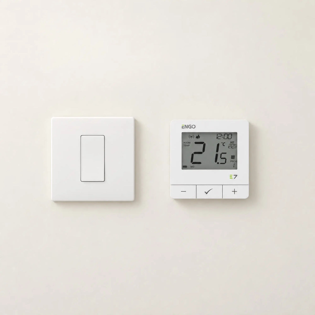 ENGO E7 thermostat in white on a wall next to a light switch